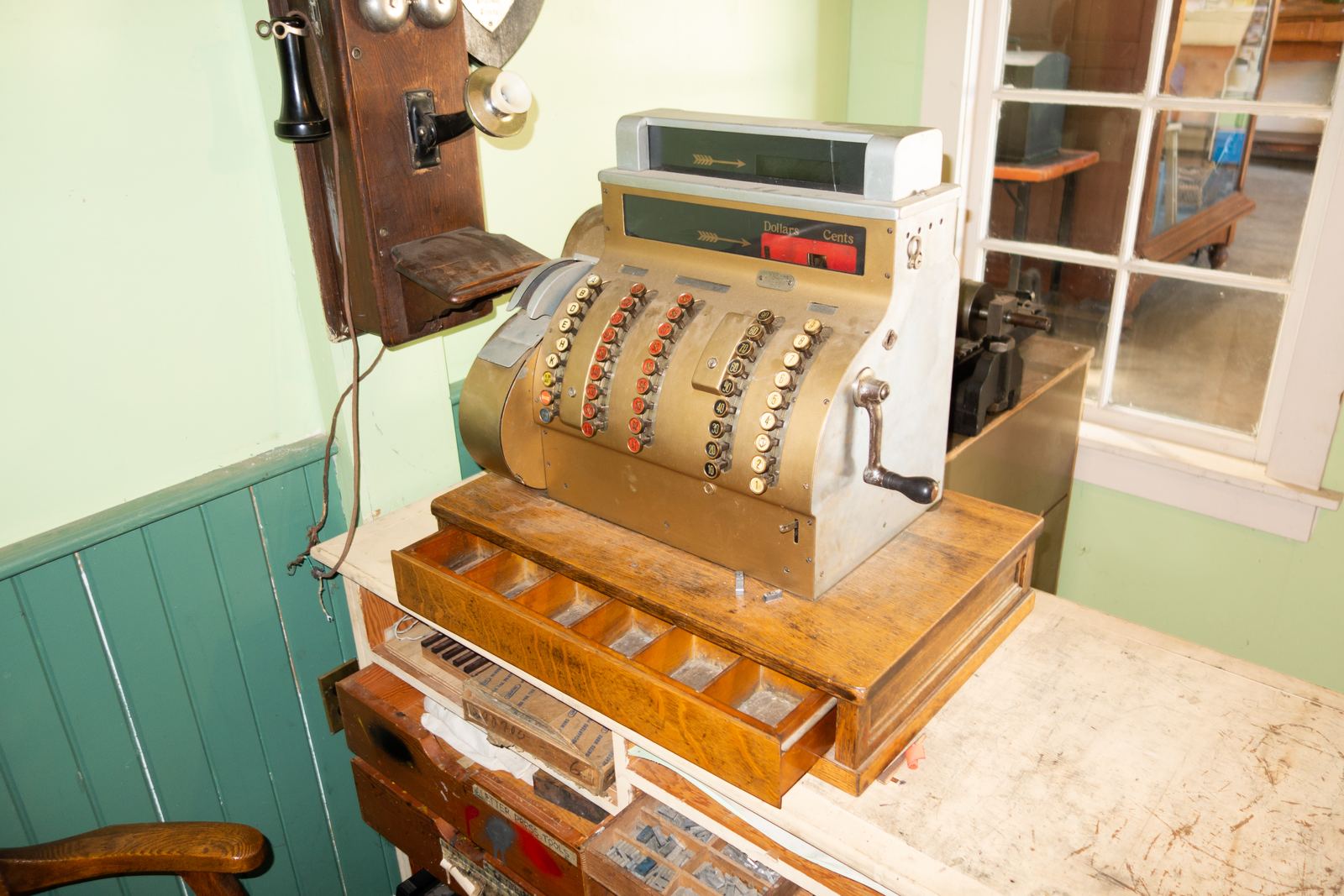 Ornate antique brass cash register on display at a heritage museum